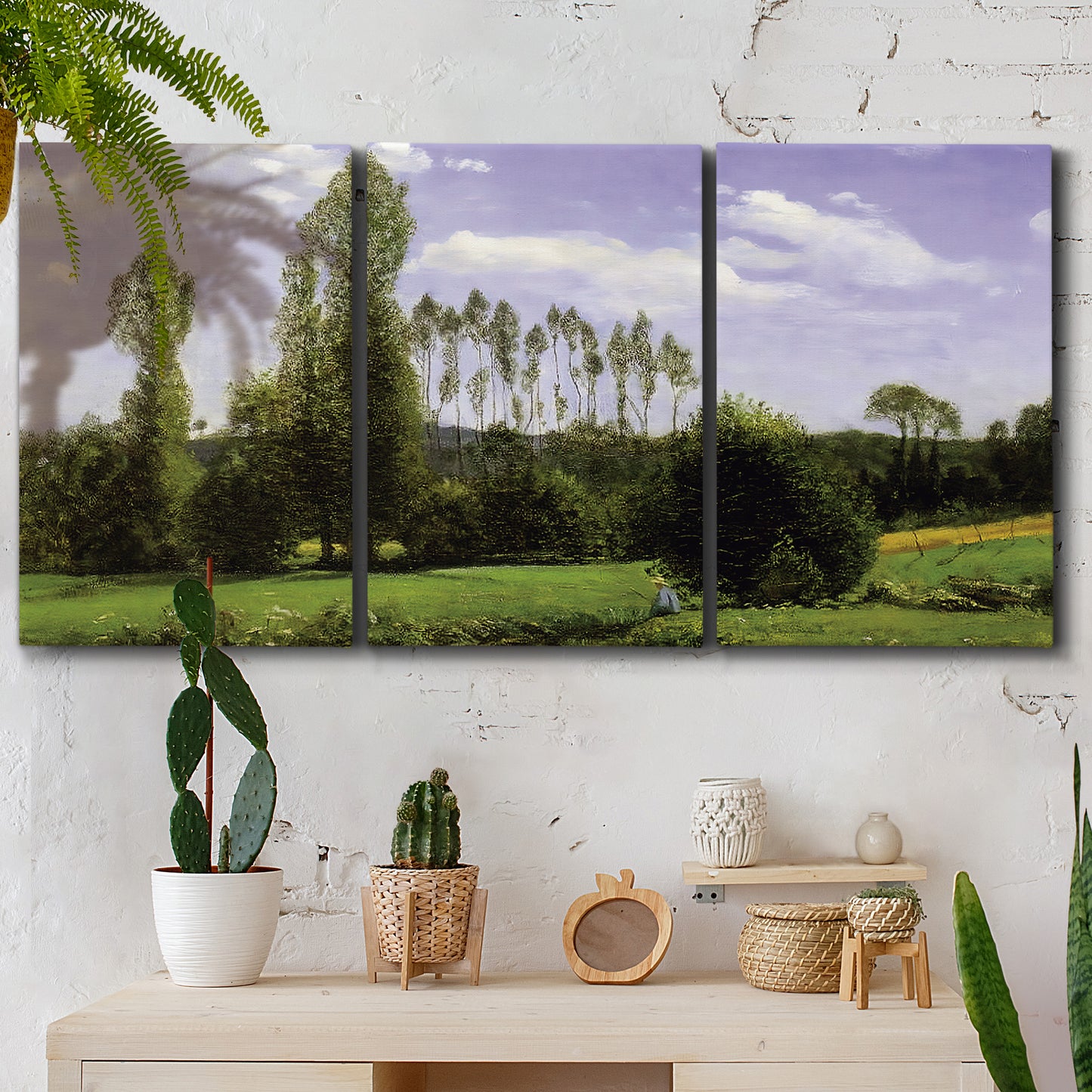 Three-panel canvas wall art featuring open landscape near le havre, displayed in a boho-chic entryway above a console table.