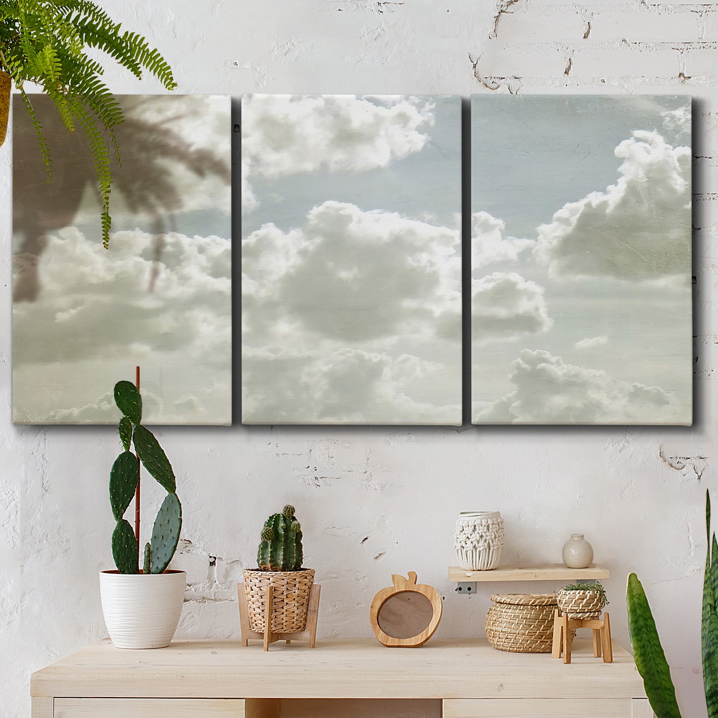 Three-panel canvas wall art featuring whimsical vertical tree landscape, displayed in a boho-chic entryway above a console table.