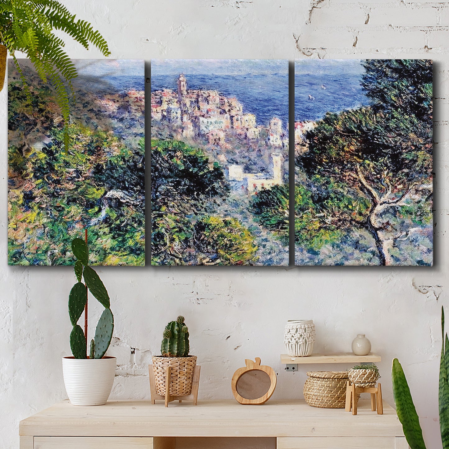 Three-panel canvas wall art featuring coastal hillside overlooking monaco, displayed in a boho-chic entryway above a console table.