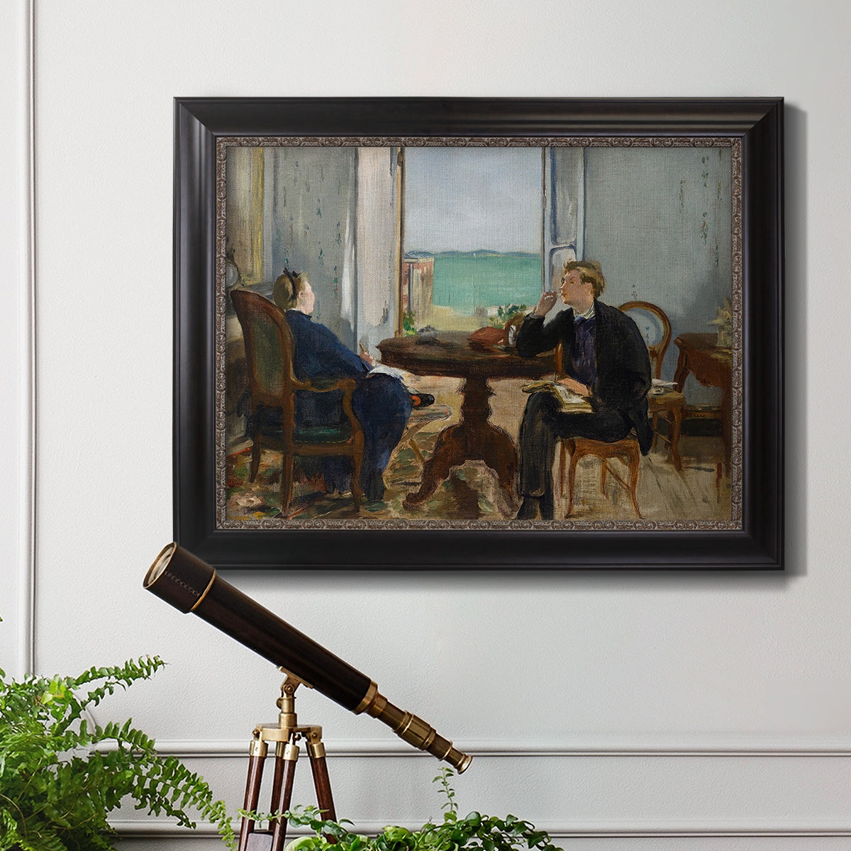 Impressionist interior scene by Édouard Manet in an ornate black frame with gilded inner detail displayed in a light-toned interior setting.
