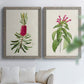 Set of two gray barnwood framed canvas prints depicting peonies thistles leafy stems and archival cream paper arranged across two complementary compositions above a sofa in a bright living space.