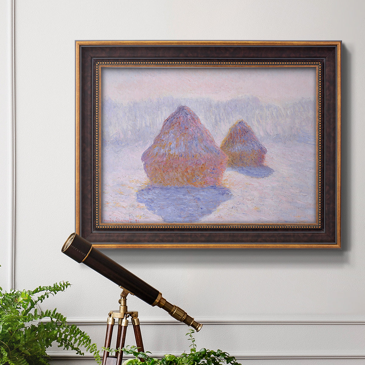 Impressionist winter haystack scene with sunlight by Claude Monet in an ornate bronzed mahogany wood frame displayed in a light-toned interior setting.
