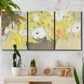 Three-panel canvas wall art featuring abstract floral table arrangement, displayed in a boho-chic entryway above a console table.