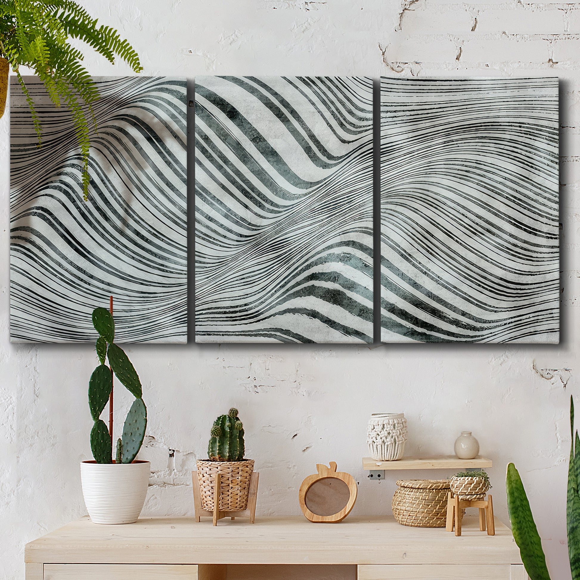 Three-panel canvas wall art featuring coastal shoreline with gentle surf, displayed in a boho-chic entryway above a console table.
