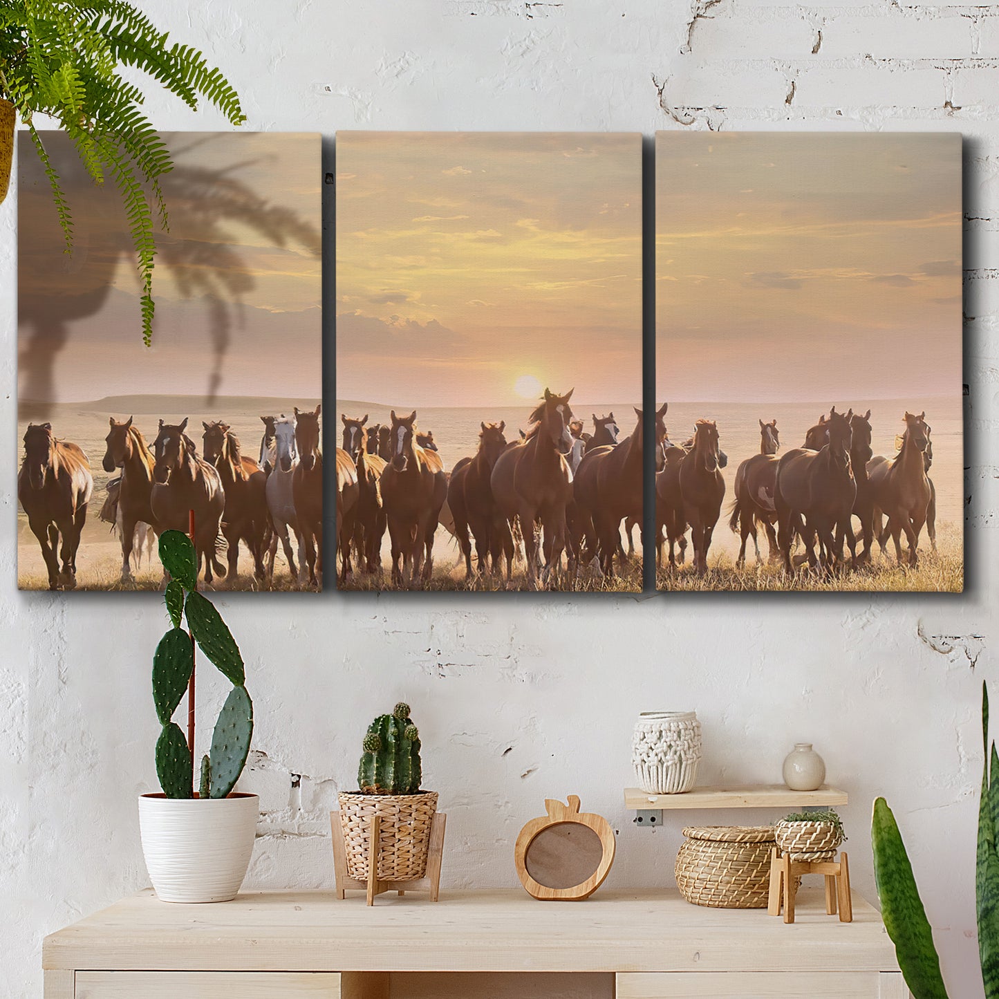 Three-panel canvas wall art featuring running horses captured in motion, displayed in a boho-chic entryway above a console table.