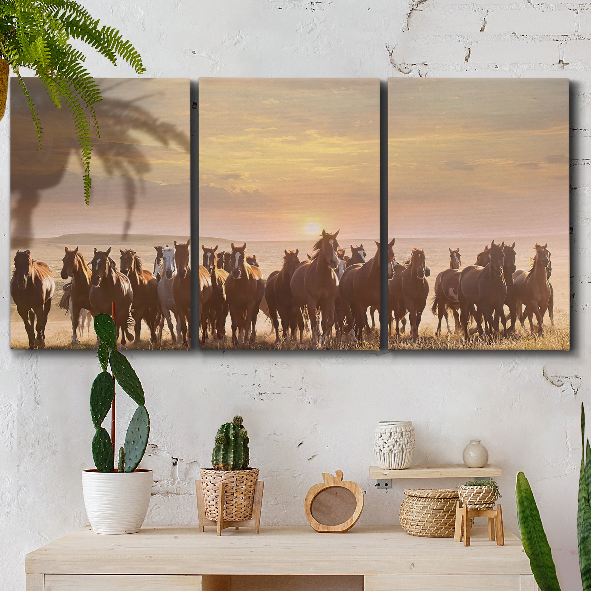 Three-panel canvas wall art featuring running horses captured in motion, displayed in a boho-chic entryway above a console table.