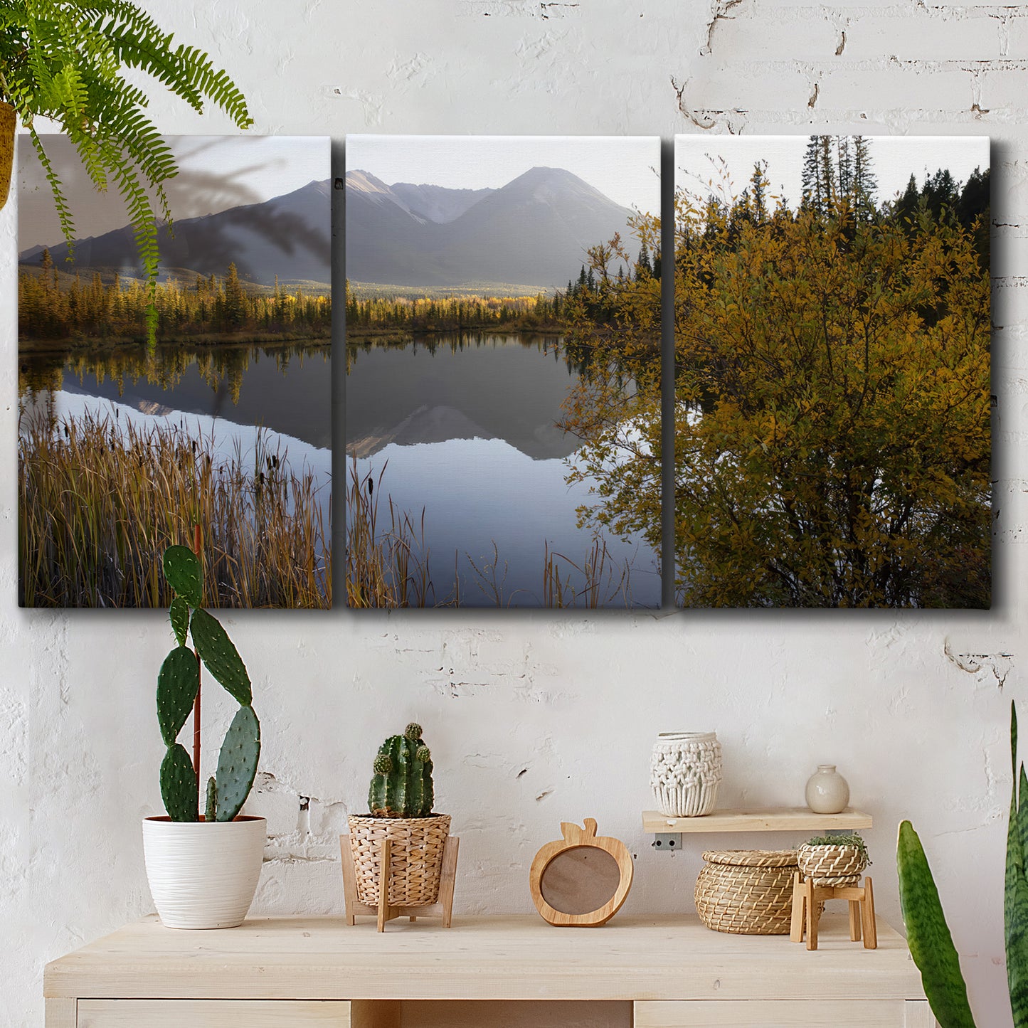 Three-panel canvas wall art featuring low light river photography, displayed in a boho-chic entryway above a console table.