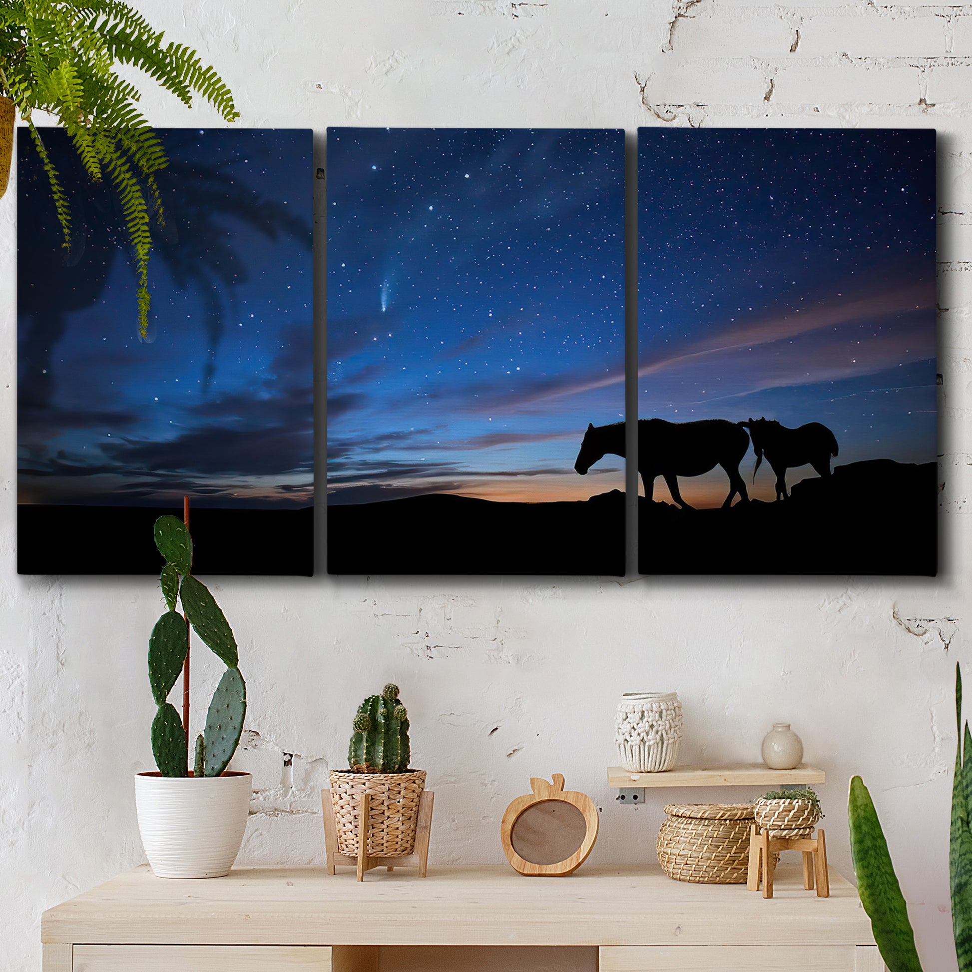 Three-panel canvas wall art featuring resting animals in open field, displayed in a boho-chic entryway above a console table.