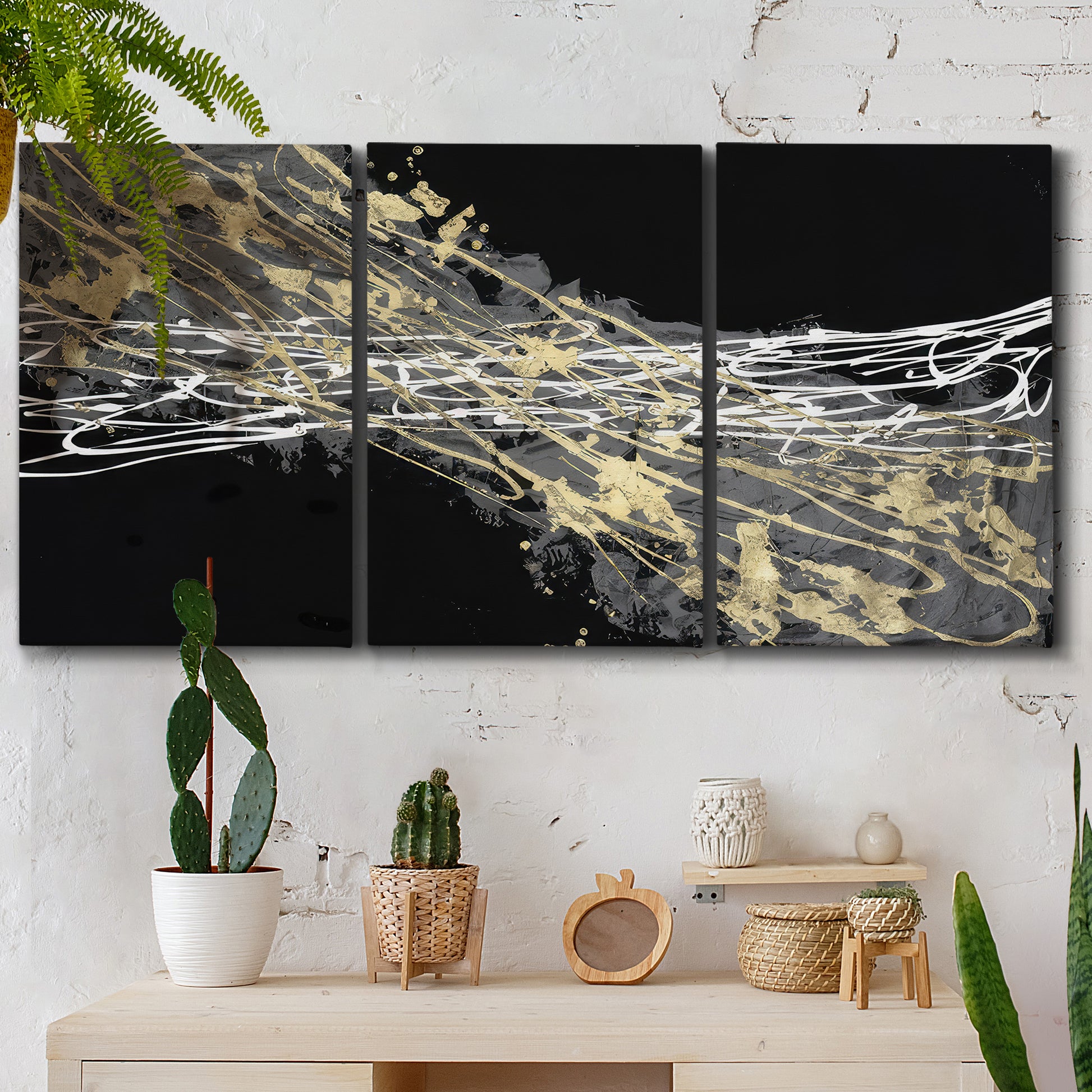 Three-panel canvas wall art featuring dark modern abstract wind patterns, displayed in a boho-chic entryway above a console table.