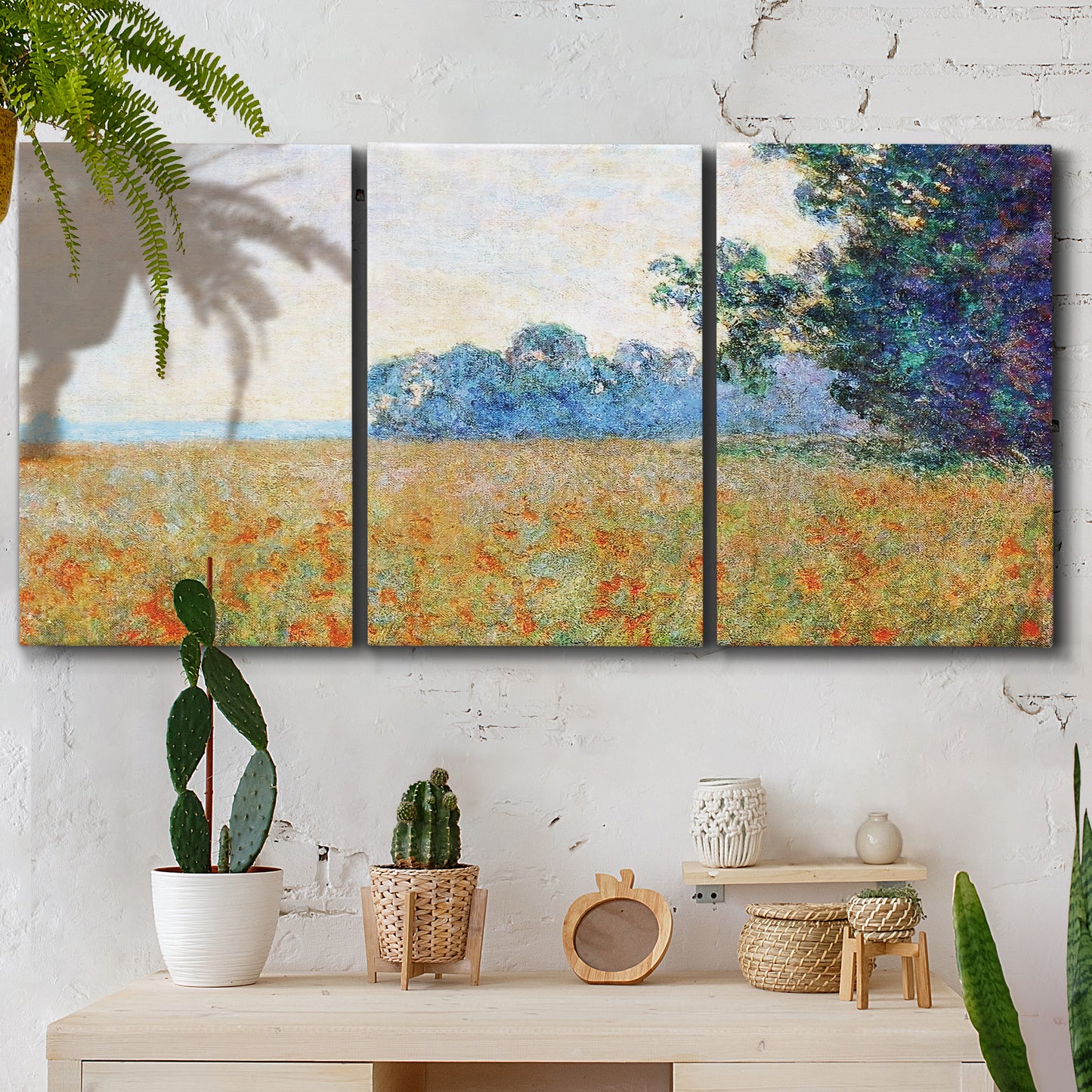 Three-panel canvas wall art featuring oat field with scattered poppies, displayed in a boho-chic entryway above a console table.