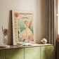 Canvas art print of a vintage advertisement featuring a stylized woman and decorative typography styled in a home decor setting.