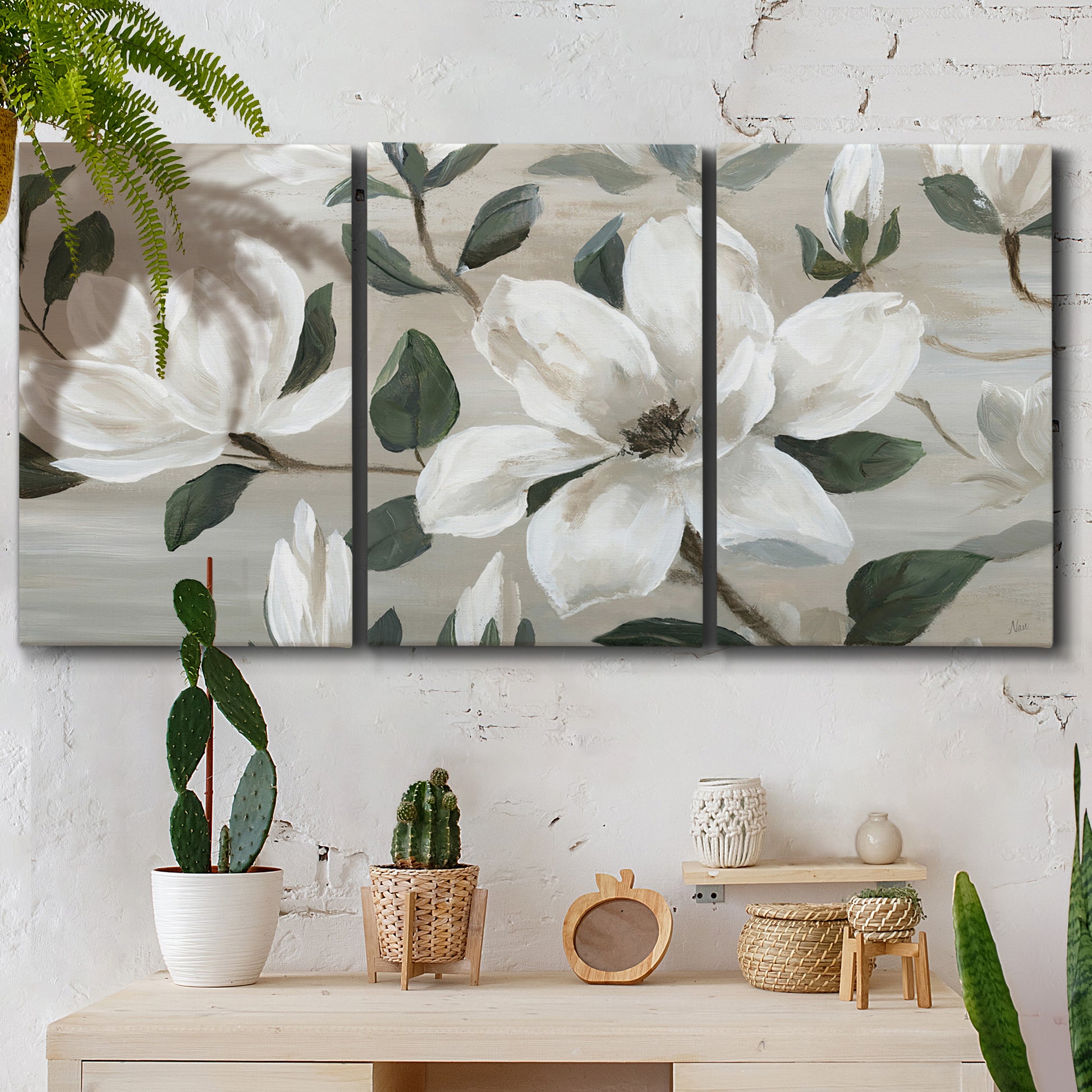 Three-panel canvas wall art featuring soft southern floral charm, displayed in a boho-chic entryway above a console table.