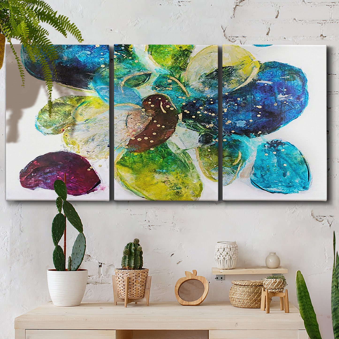 Three-panel canvas wall art featuring expressive abstract color interpretations, displayed in a boho-chic entryway above a console table.