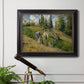 Impressionist countryside harvest scene by Camille Pissarro in an ornate black frame with gilded inner detail displayed in a light-toned interior setting.