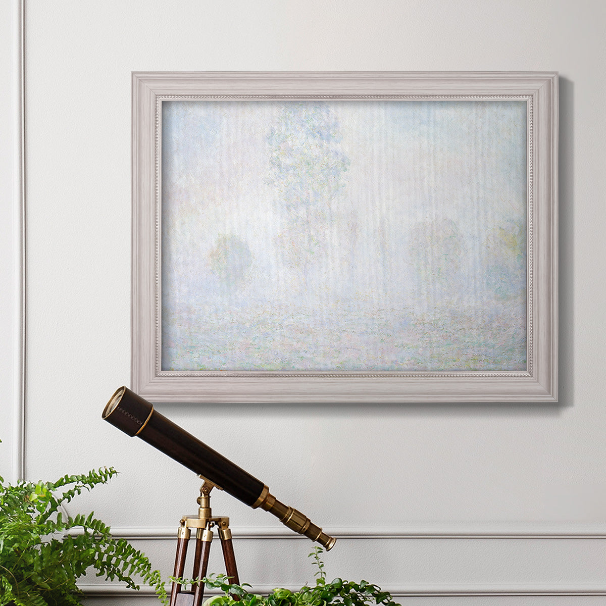 Impressionist atmospheric landscape in morning haze by Claude Monet in an ornate weathered white frame displayed in a light-toned interior setting.