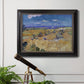 Impressionist wheat harvest scene by Vincent van Gogh in an ornate black frame with gilded inner detail displayed in a light-toned interior setting.