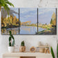 Three-panel canvas wall art featuring river flowing past village, displayed in a boho-chic entryway above a console table.