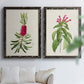 Set of two black barnwood framed canvas prints depicting peonies thistles leafy stems and archival cream paper arranged across two complementary compositions above a sofa in a bright living space.