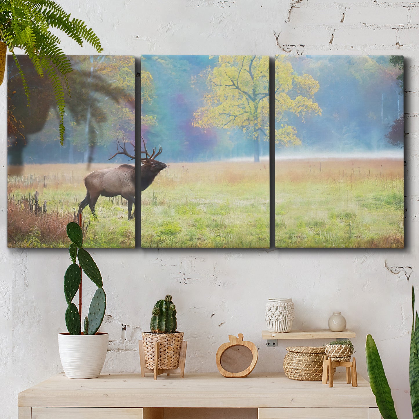 Three-panel canvas wall art featuring resting animals in open field, displayed in a boho-chic entryway above a console table.