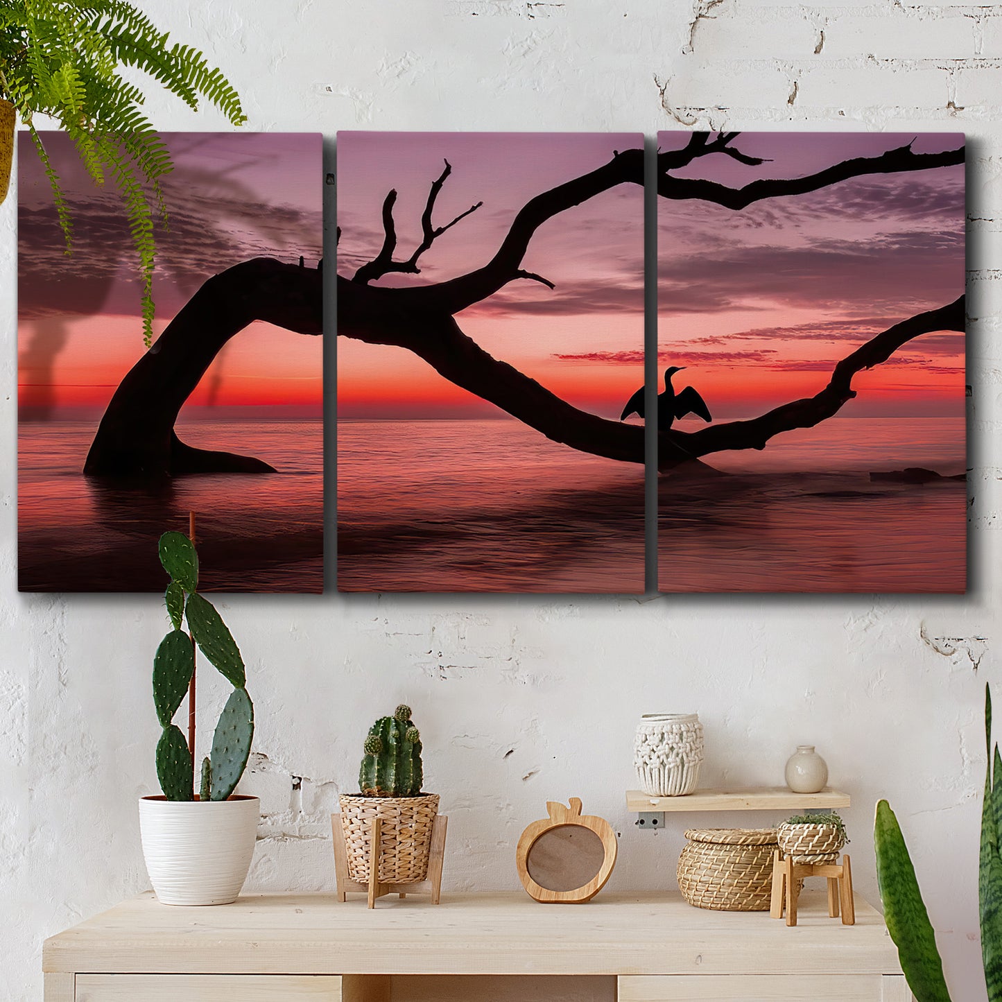 Three-panel canvas wall art featuring sunset beach photography, displayed in a boho-chic entryway above a console table.