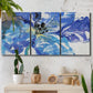 Three-panel canvas wall art featuring blue floral botanical close up, displayed in a boho-chic entryway above a console table.