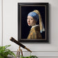 Iconic portrait of a girl wearing a pearl earring by Johannes Vermeer in an ornate black frame with gilded inner detail displayed in a light-toned interior setting.