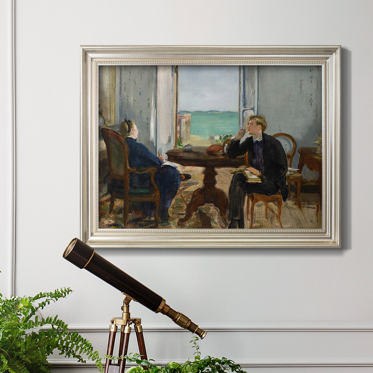 Impressionist interior scene by Édouard Manet in an ornate champagne frame displayed in a light-toned interior setting.