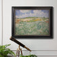 Impressionist countryside landscape near Auvers by Vincent van Gogh in an ornate black frame with gilded inner detail displayed in a light-toned interior setting.
