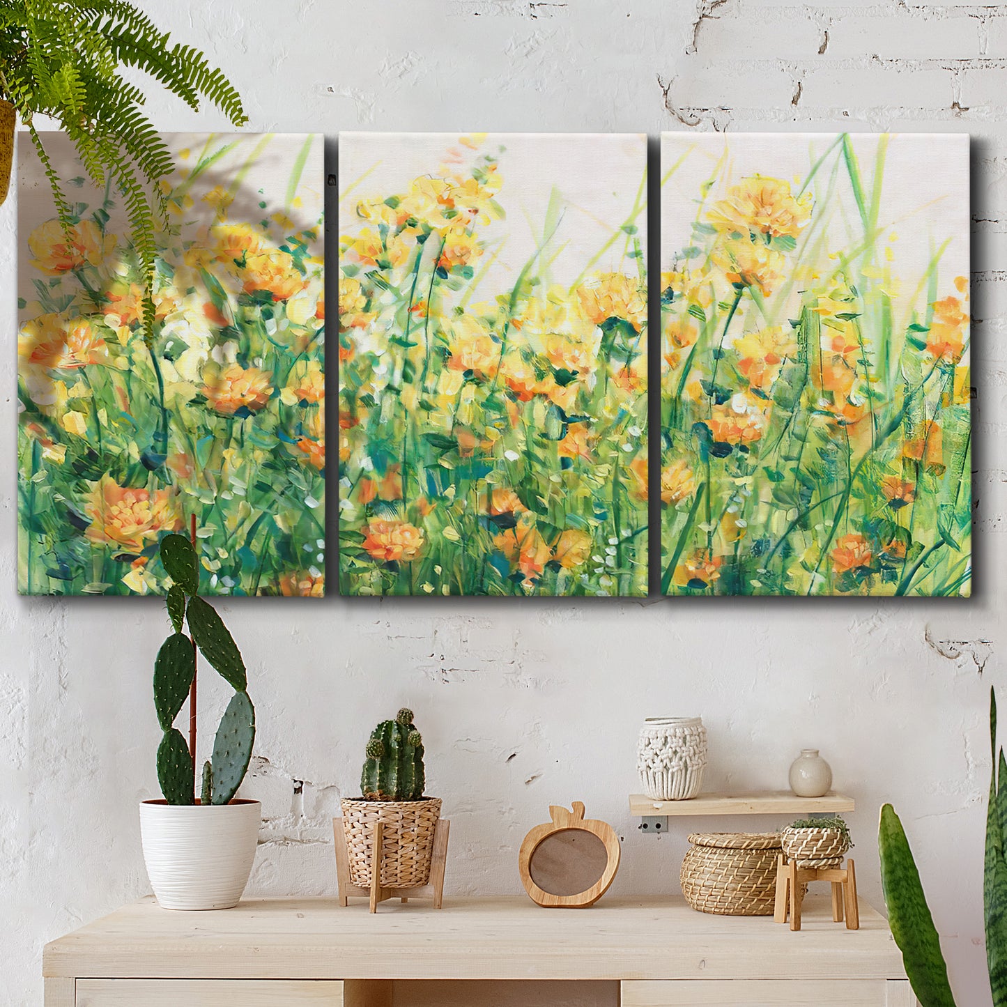 Three-panel canvas wall art featuring colorful garden flowers in bloom, displayed in a boho-chic entryway above a console table.