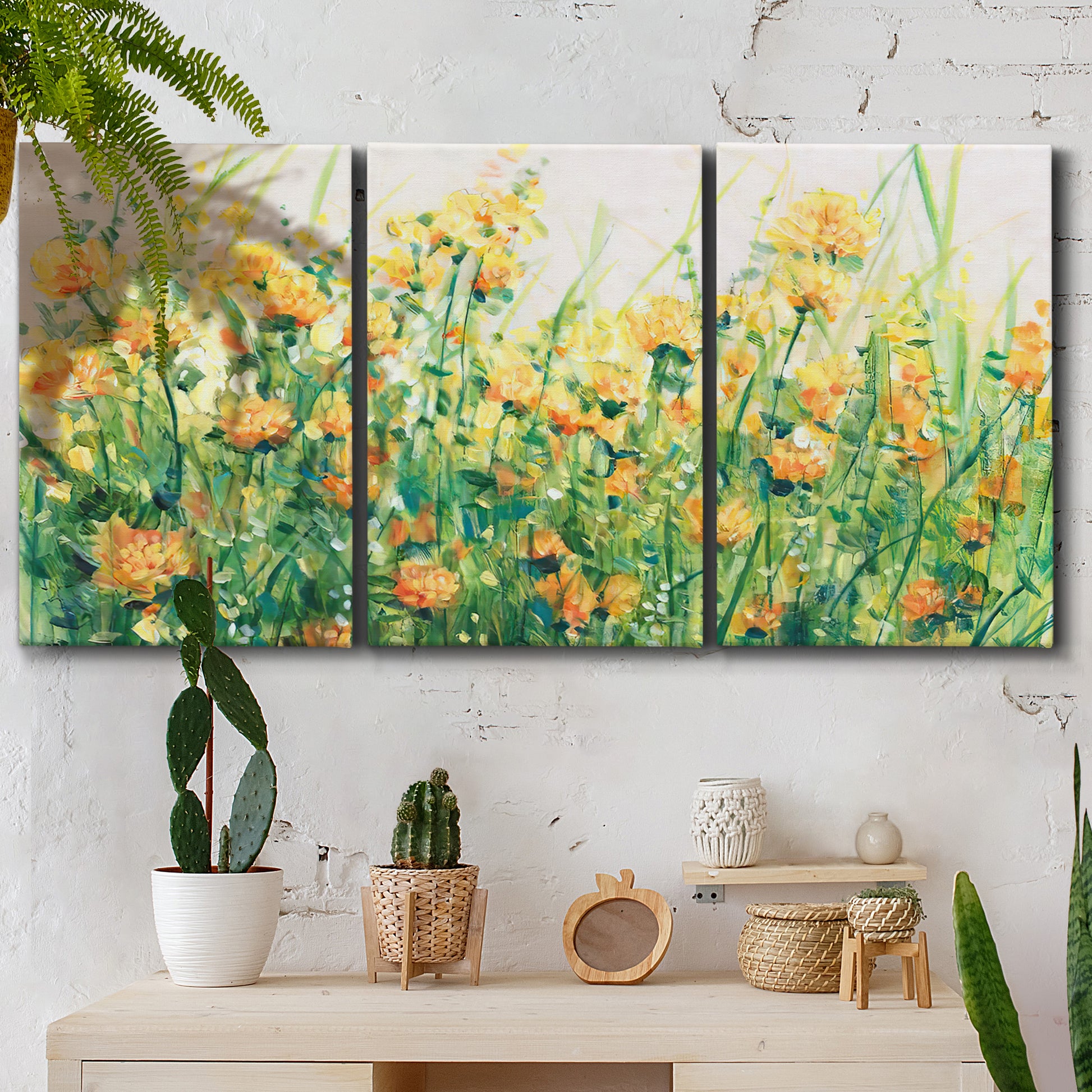 Three-panel canvas wall art featuring colorful garden flowers in bloom, displayed in a boho-chic entryway above a console table.