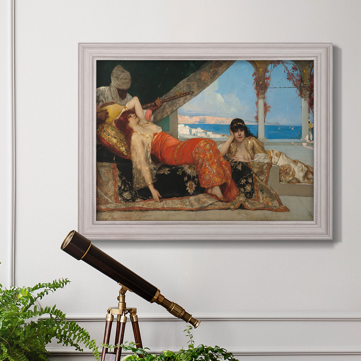 Orientalist portrait scene by Jean-Joseph Benjamin-Constant in an ornate weathered white frame displayed in a light-toned interior setting.