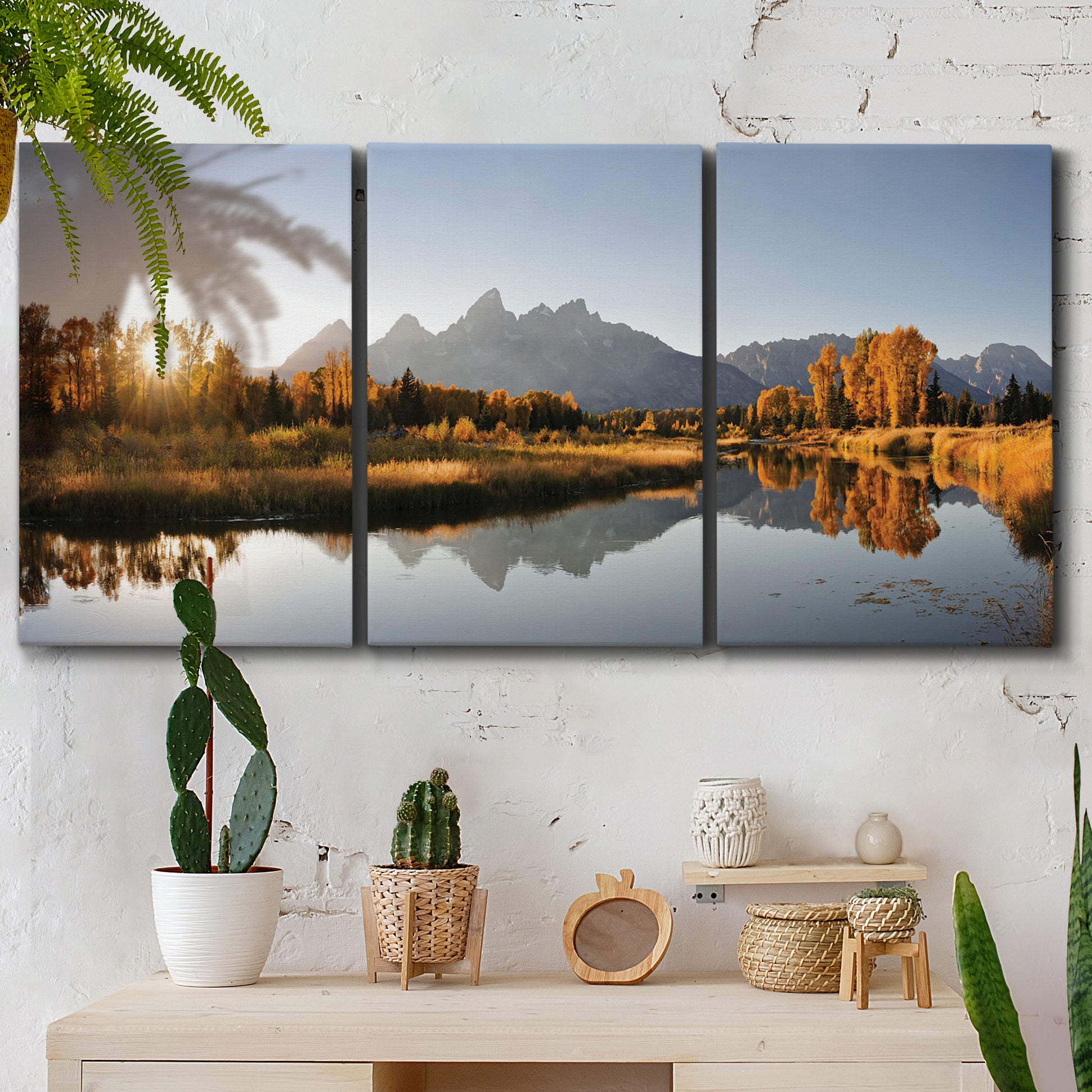 Three-panel canvas wall art featuring river canyon landscape photograph, displayed in a boho-chic entryway above a console table.