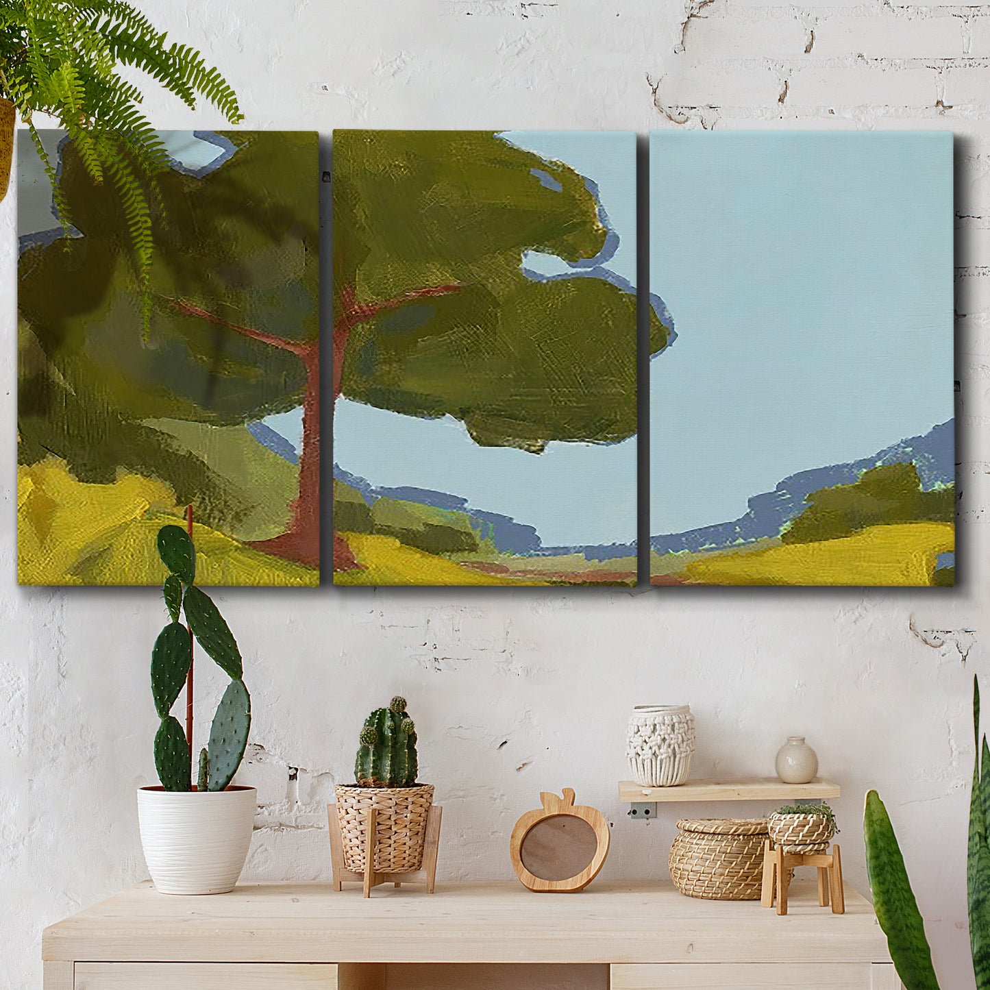 Three-panel canvas wall art featuring sunlit public park landscape view, displayed in a boho-chic entryway above a console table.