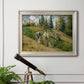 Impressionist countryside harvest scene by Camille Pissarro in an ornate champagne frame displayed in a light-toned interior setting.
