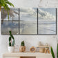 Three-panel canvas wall art featuring endless beach meeting ocean horizon, displayed in a boho-chic entryway above a console table.