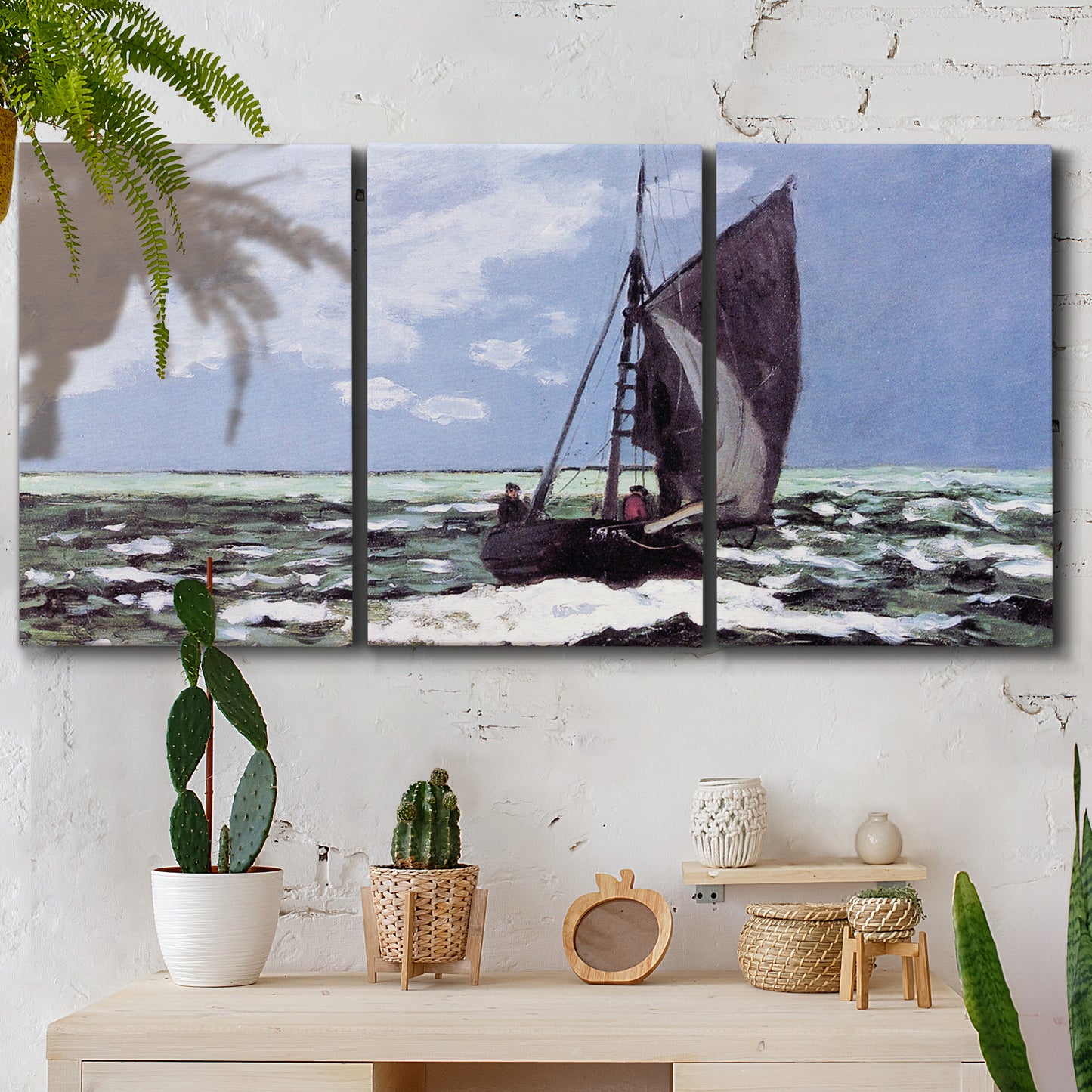 Three-panel canvas wall art featuring stormy sea with crashing waves, displayed in a boho-chic entryway above a console table.