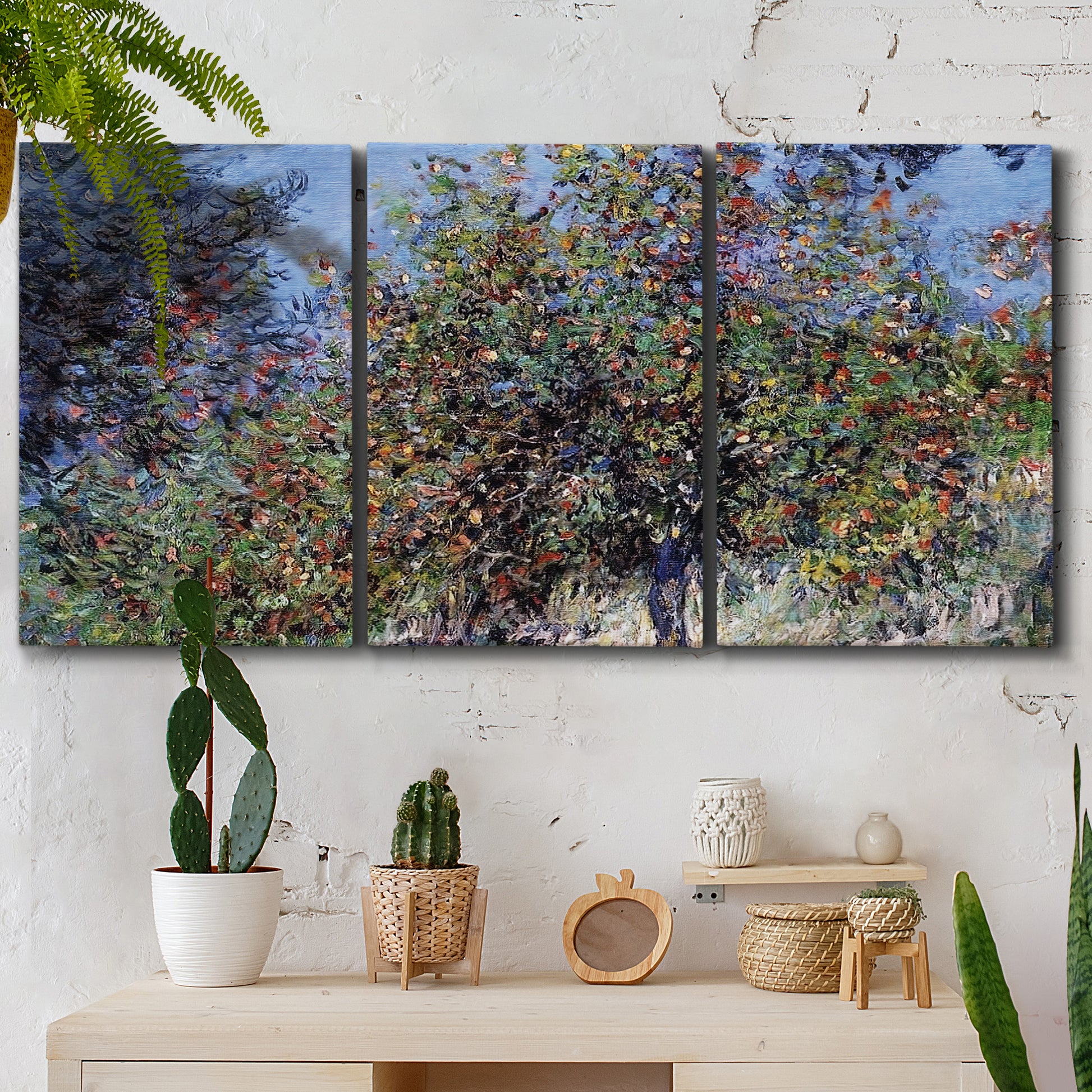 Three-panel canvas wall art featuring orchard of trees in spring bloom, displayed in a boho-chic entryway above a console table.
