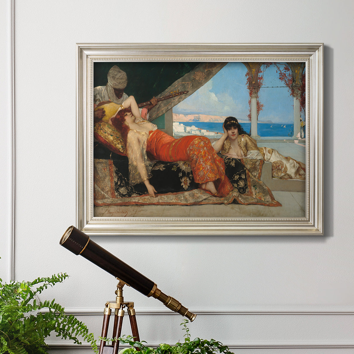 Orientalist portrait scene by Jean-Joseph Benjamin-Constant in an ornate champagne frame displayed in a light-toned interior setting.