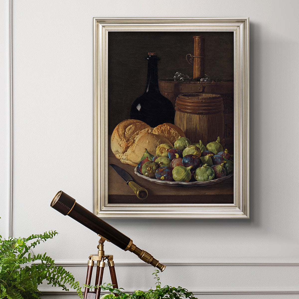 Realist still life with figs and bread by Luis Meléndez in an ornate champagne frame displayed in a light-toned interior setting.