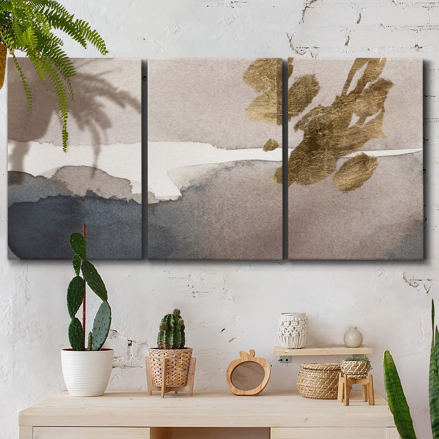 Three-panel canvas wall art featuring abstract watercolor with gold accents, displayed in a boho-chic entryway above a console table.