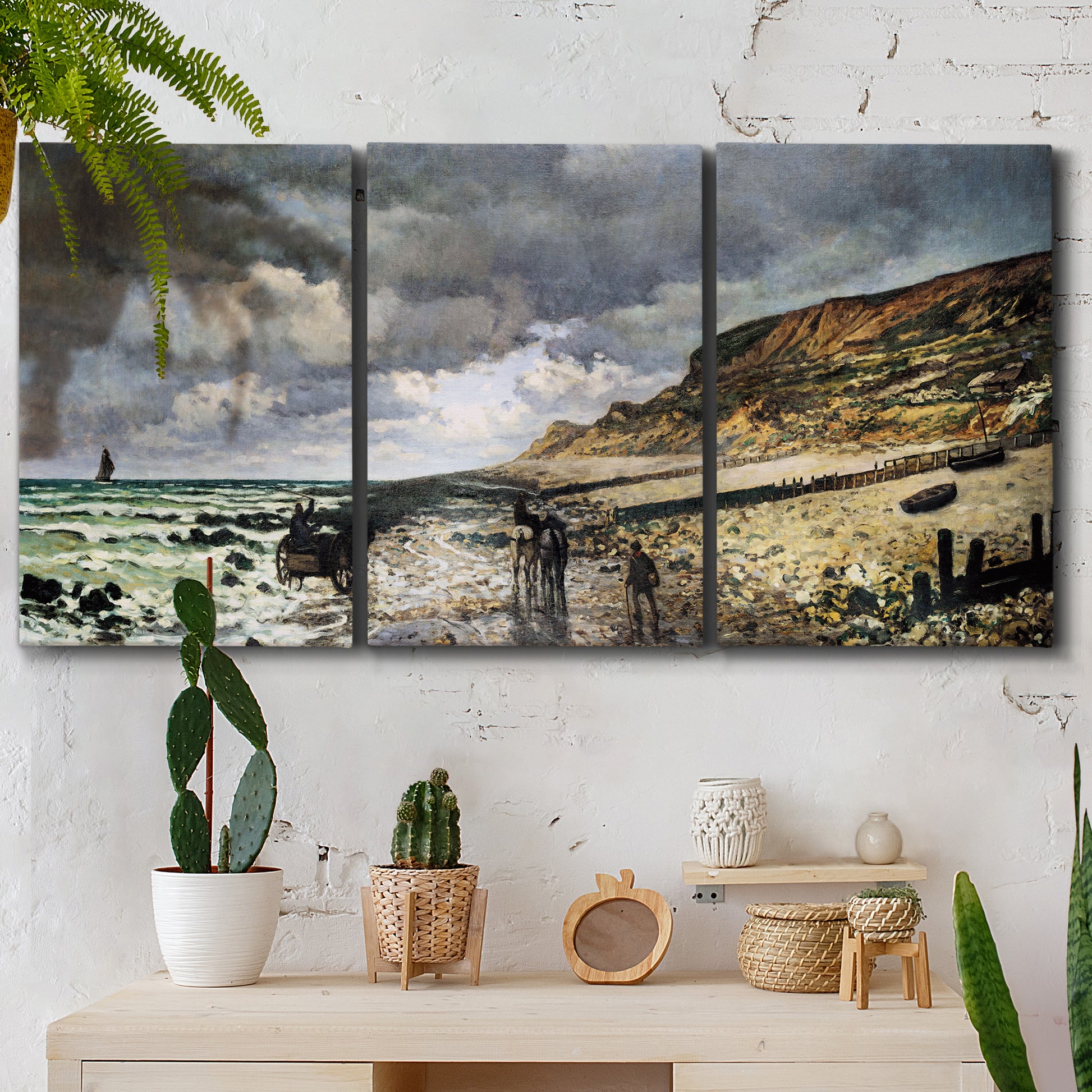 Three-panel canvas wall art featuring sunset beach with glowing sky, displayed in a boho-chic entryway above a console table.