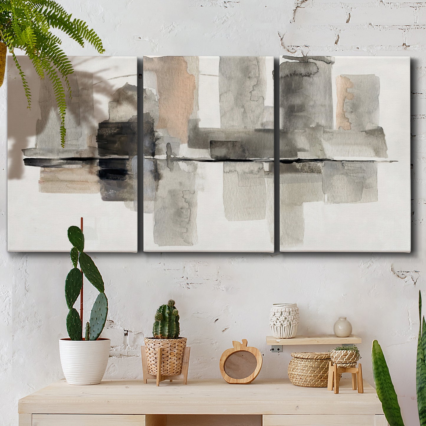 Three-panel canvas wall art featuring urban abstract watercolor oasis, displayed in a boho-chic entryway above a console table.