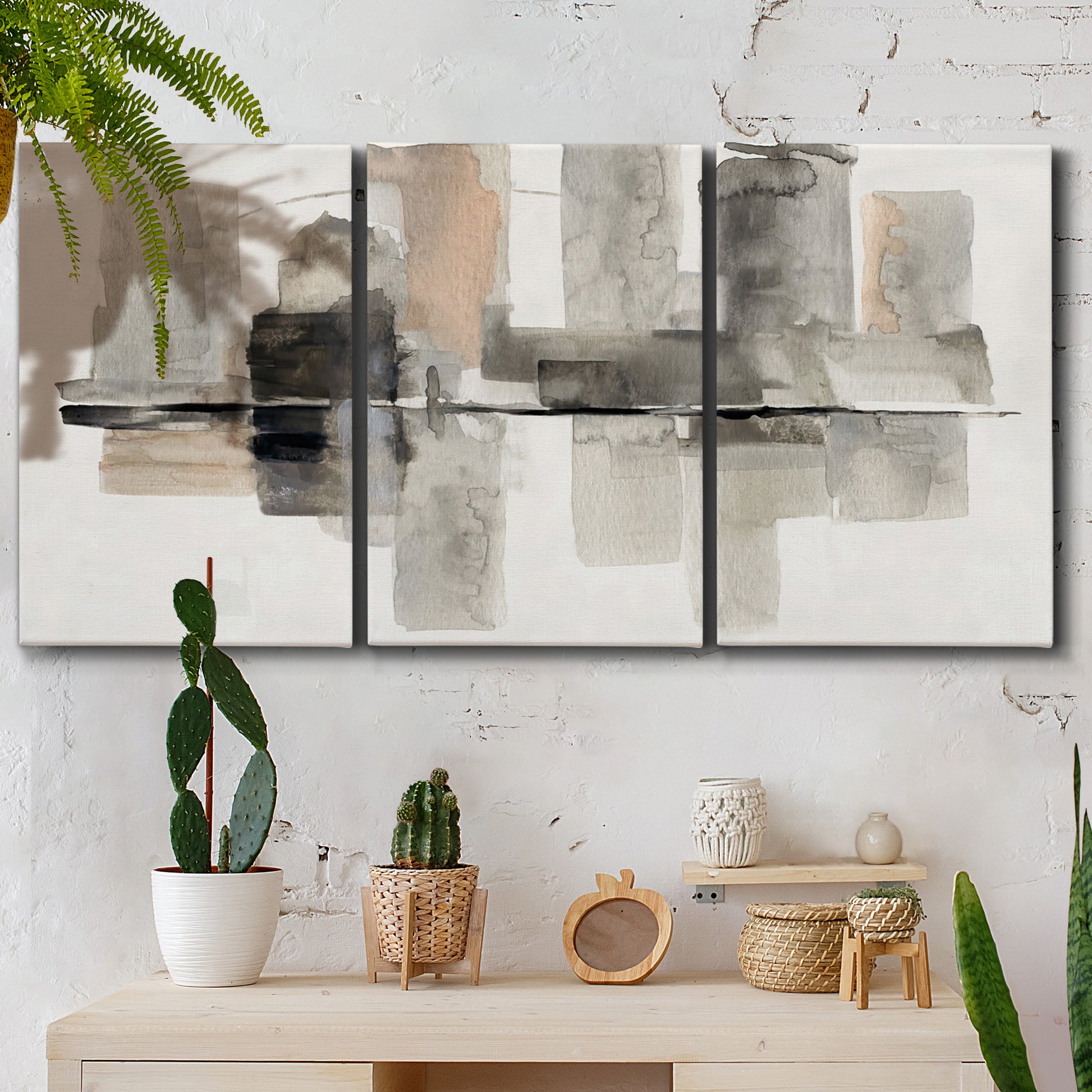 Three-panel canvas wall art featuring urban abstract watercolor oasis, displayed in a boho-chic entryway above a console table.