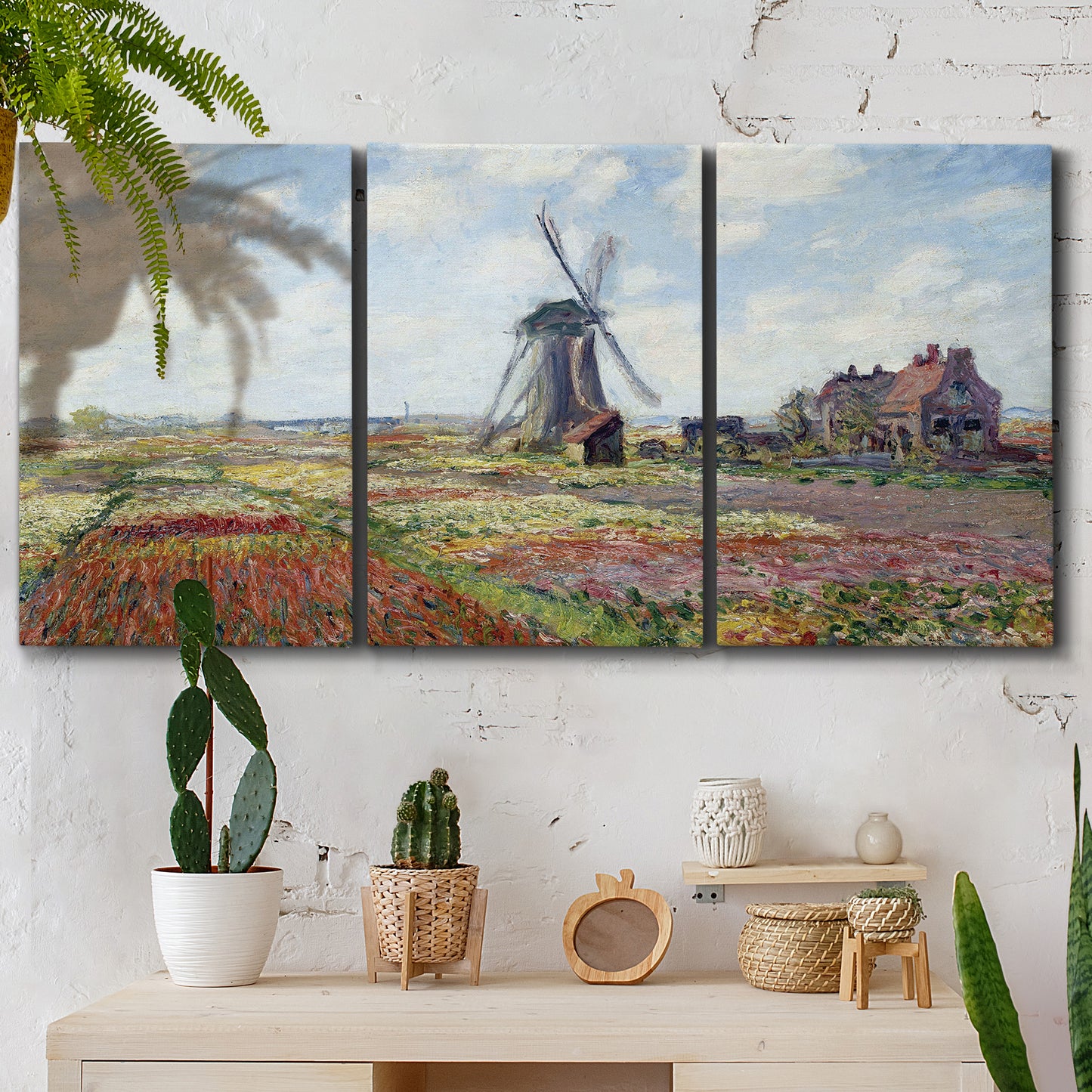 Three-panel canvas wall art featuring tulip fields with windmill, displayed in a boho-chic entryway above a console table.