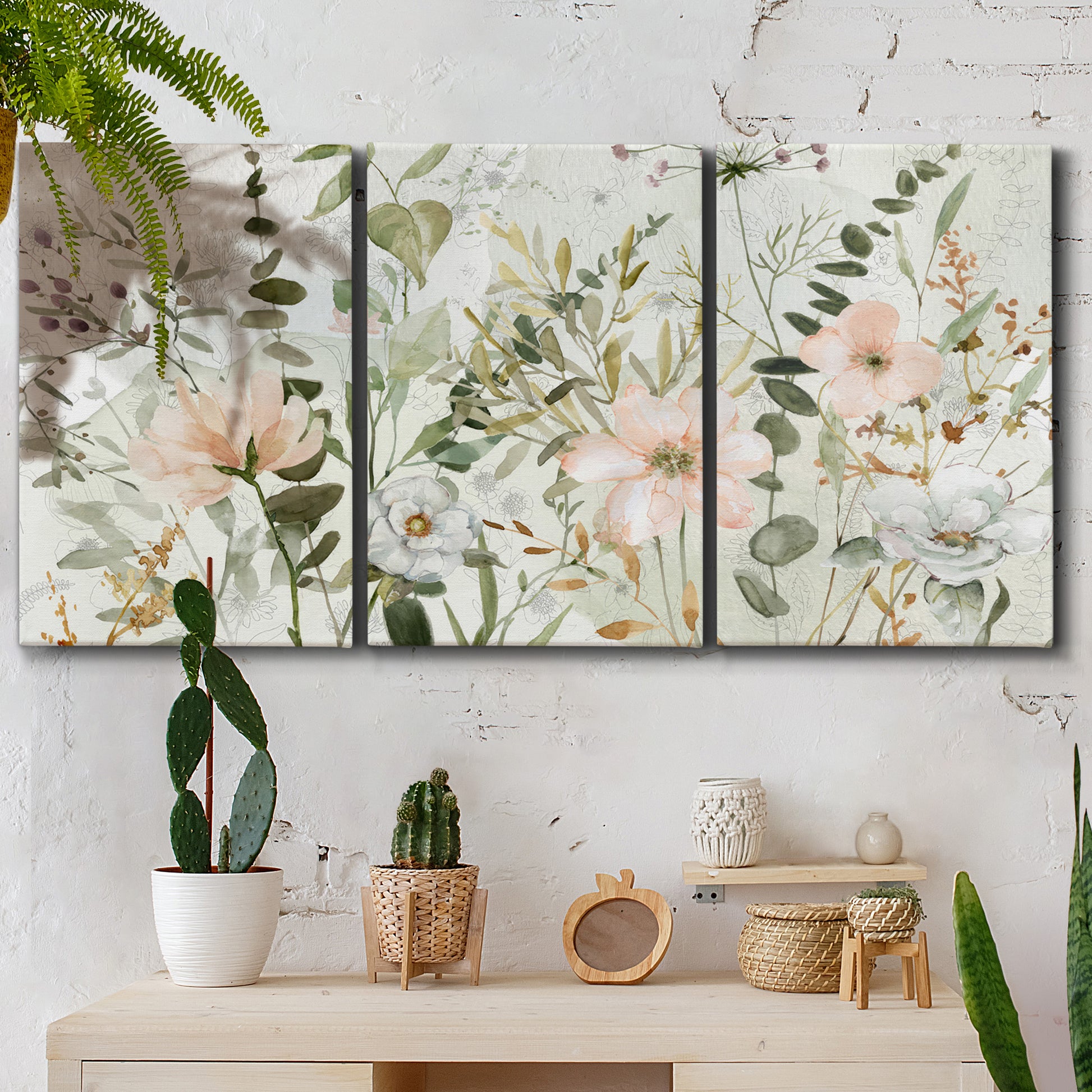 Three-panel canvas wall art featuring vintage floral botanical sketchbook, displayed in a boho-chic entryway above a console table.