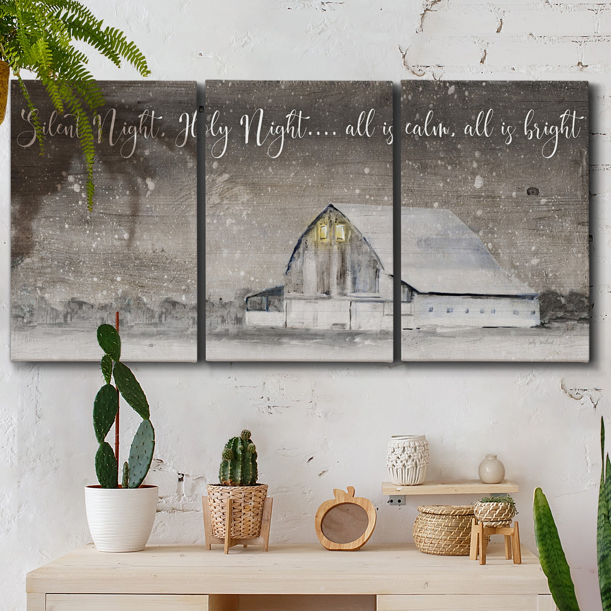 Three-panel canvas wall art featuring rustic winter holiday text art, displayed in a boho-chic entryway above a console table.