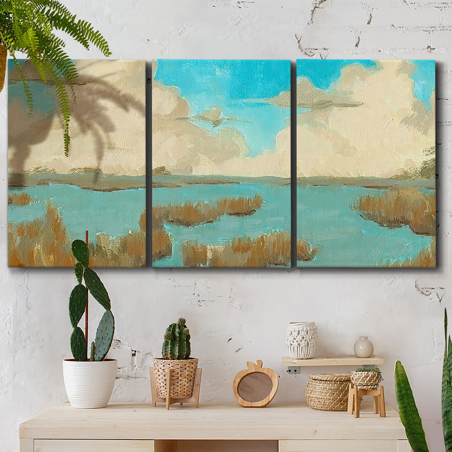 Three-panel canvas wall art featuring abstract pond scene with reflections, displayed in a boho-chic entryway above a console table.