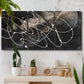 Three-panel canvas wall art featuring dark swirling abstract motion, displayed in a boho-chic entryway above a console table.