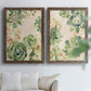 Set of two walnut barnwood framed canvas prints depicting green rosettes, peach blossoms, and mosaic-like outlines arranged across two complementary compositions above a sofa in a bright living space.