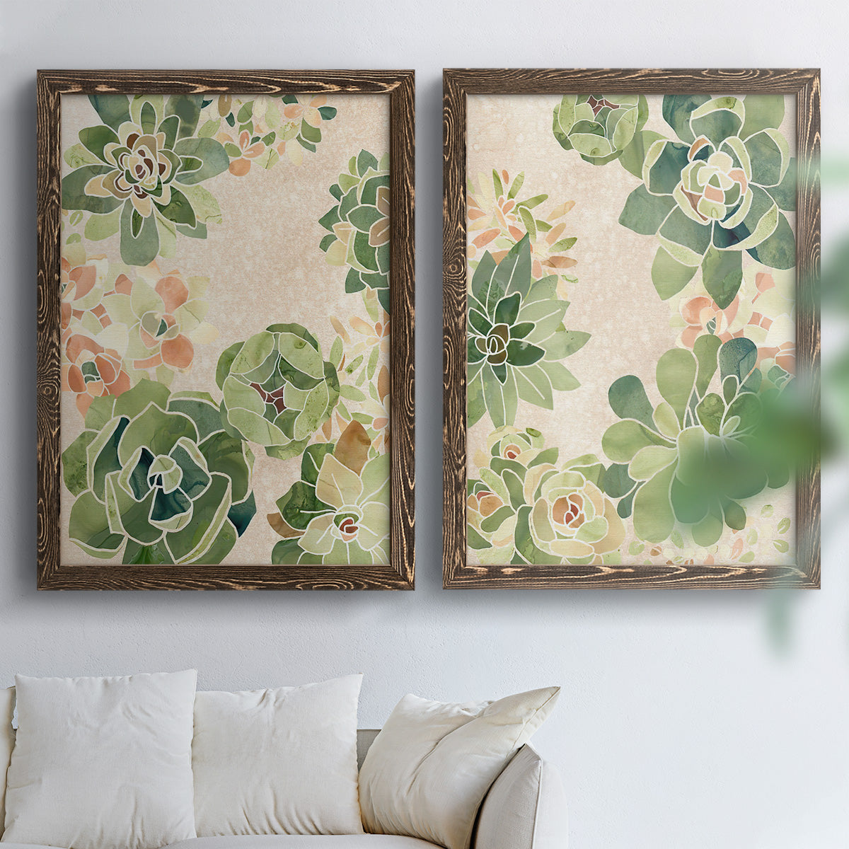 Set of two walnut barnwood framed canvas prints depicting green rosettes, peach blossoms, and mosaic-like outlines arranged across two complementary compositions above a sofa in a bright living space.